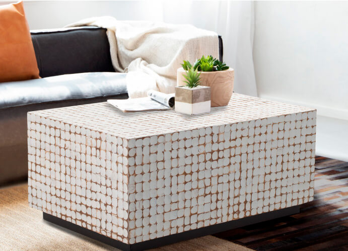 Living room with Iarge coffee table made of mango wood and painted coconut tile detail.